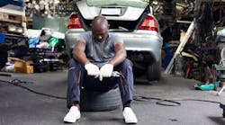 Technician resting on tire