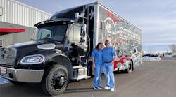 Bourdon and wife Monica in front of their truck.