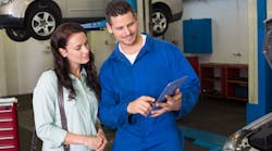 Male technician showing tablet to female customer