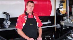 Jessie Snyder of the Kalitta Motorsports crew prepares to disassemble the engine.